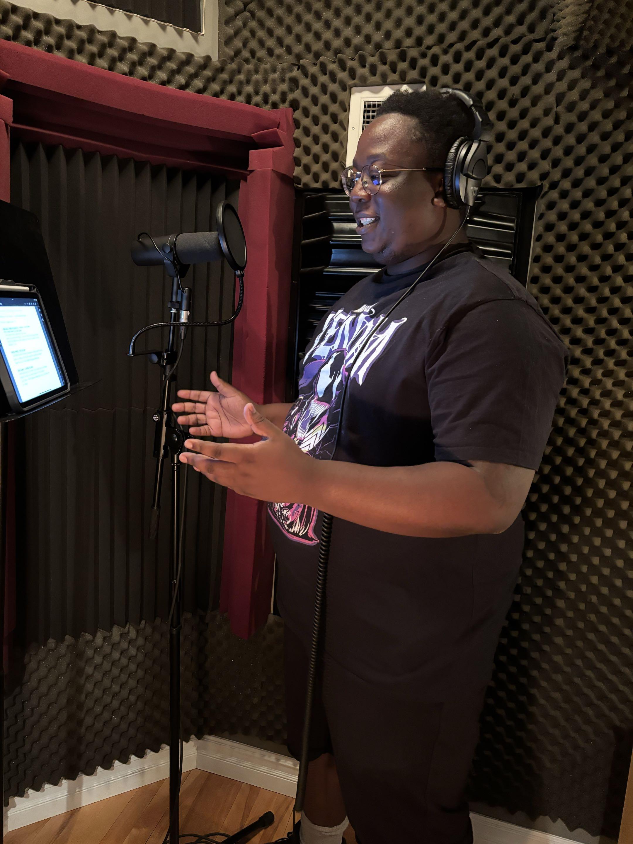 Sempa Mpagi recording in a voiceover studio